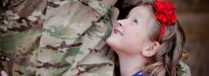 Child looking at her military father