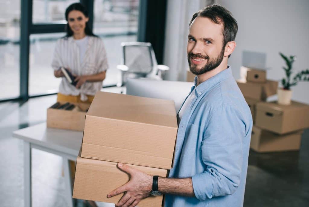 guy-holding-a-box-in-the-office