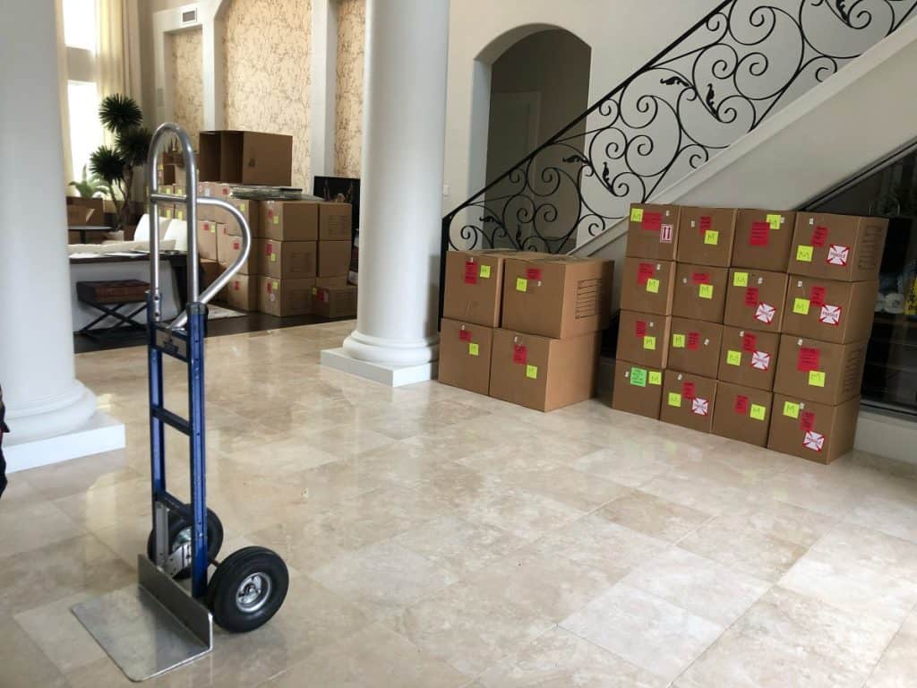 houston packing and moving boxes by stairs with a trolly