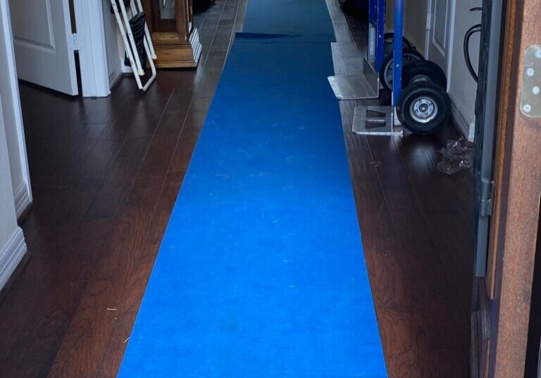 Blue floor runner protecting a hallway floor during a Blue Ox move